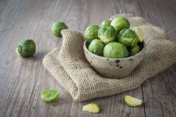 Brussel sprouts in a wooden bowl.